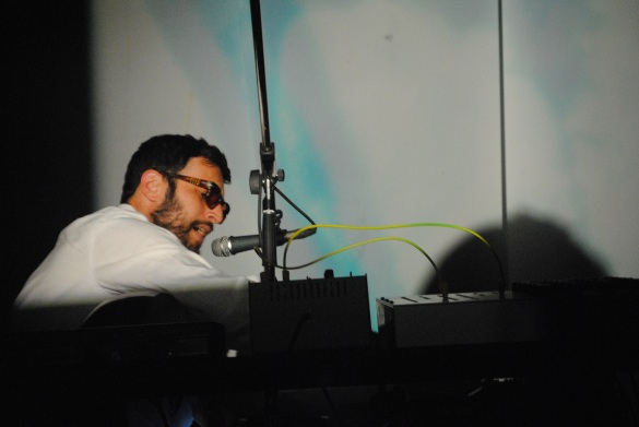 Radwan Ghazi Moumneh sings while tweaking delay speeds as Malena Szlam Salazar uses three 16mm projectors to send visuals onto screens behind him on the stage. Photo: Tom Beedham